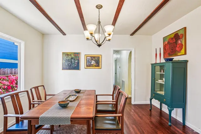 a view of a dining room with furniture wooden floor and a chandelier
