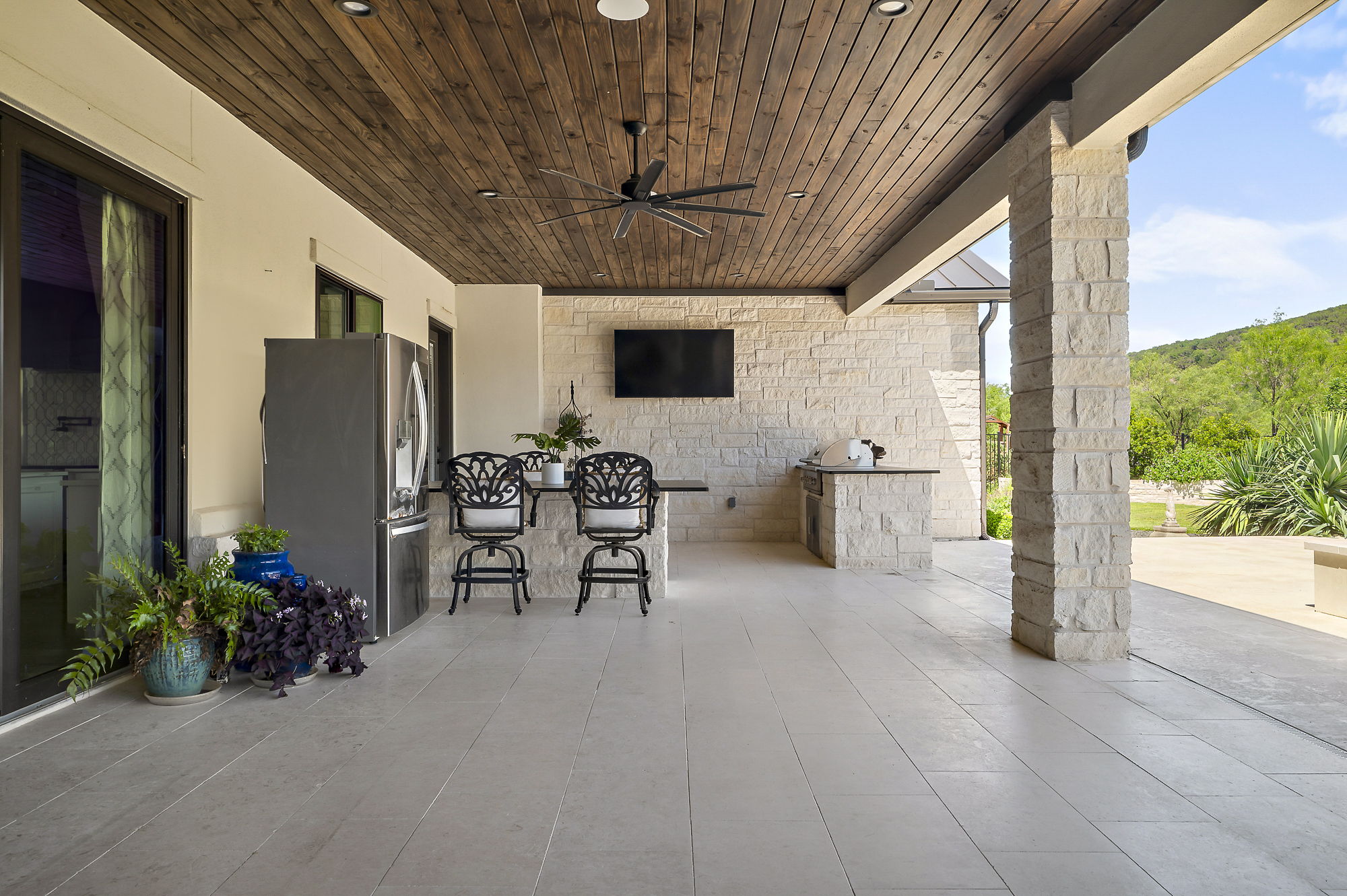 811 Wade Road Canyon Lake, TX 78132 - Photo 28 of 40 View of patio with a ceiling fan, area for grilling, and a grill