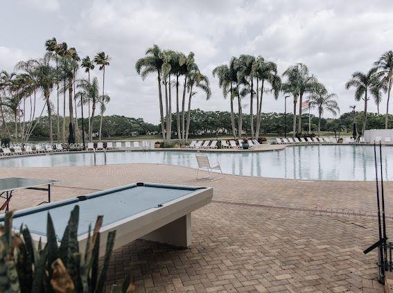 10245 Vía Hibiscus, Unit 10245 Boca Raton, FL 33428 - Photo 22 of 28 a view of swimming pool with outdoor seating and lake