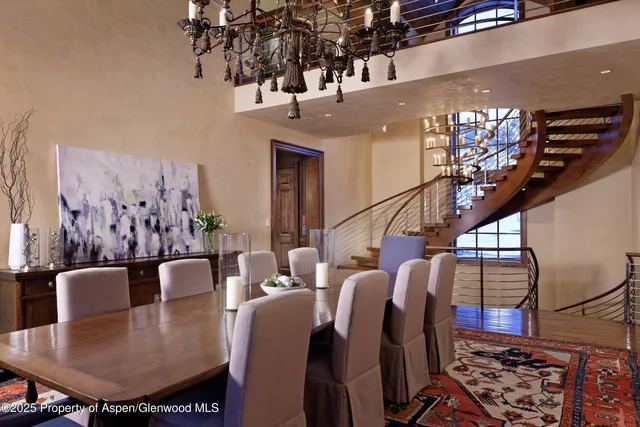 a kitchen with a sink a counter and chairs