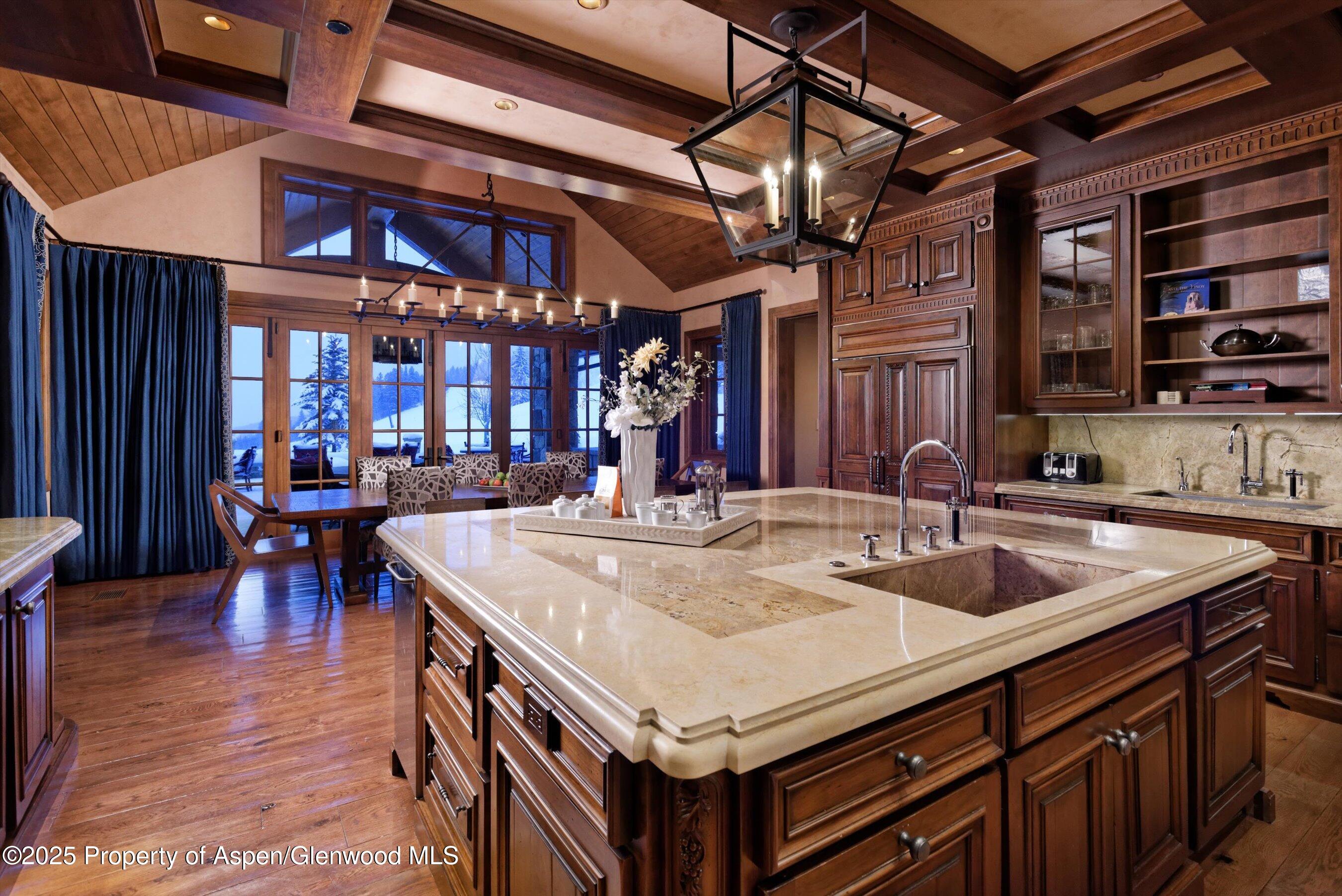 220 Buttermilk Lane Aspen, CO 81611 - Photo 14 of 60 a kitchen with a sink a counter and chairs