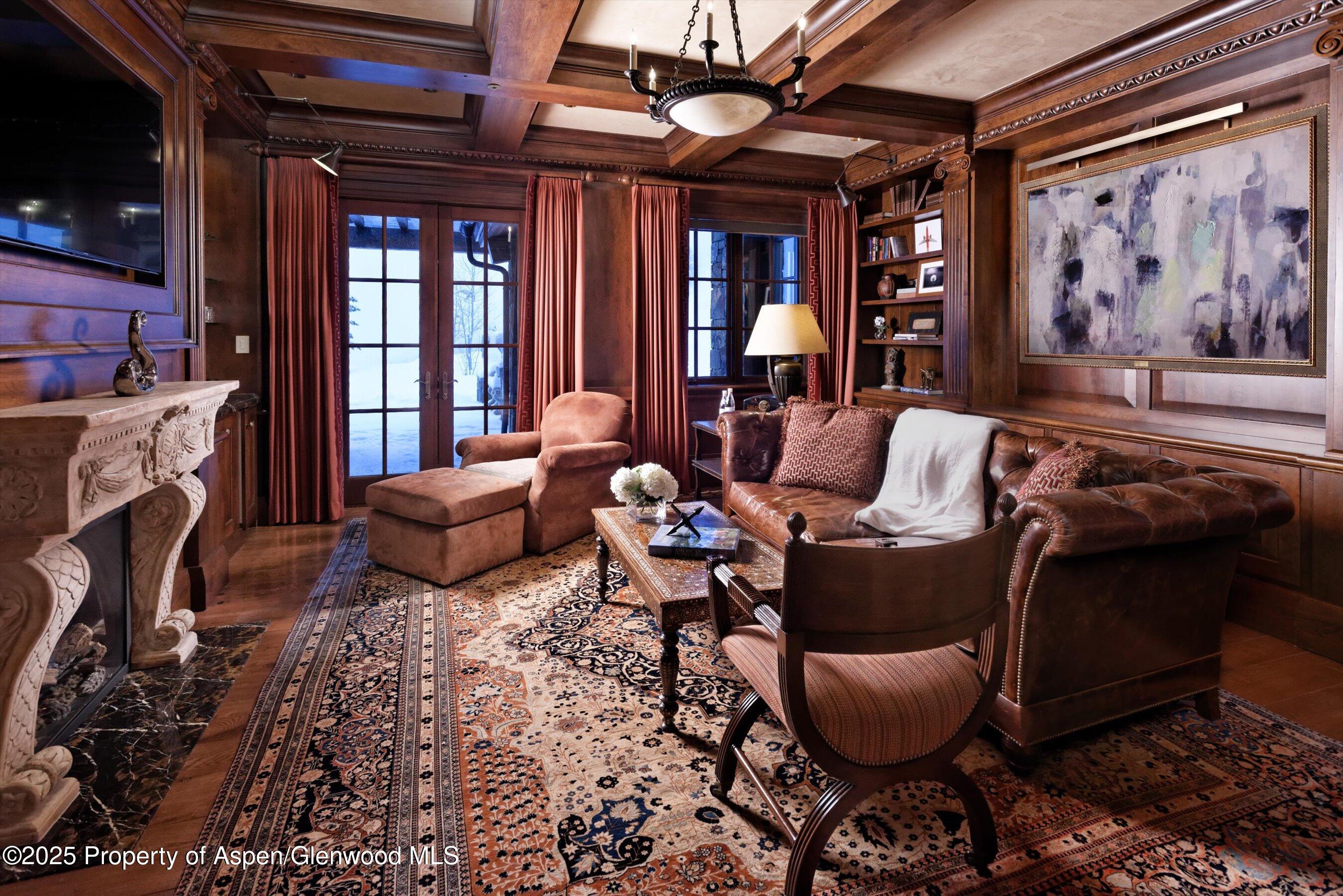 220 Buttermilk Lane Aspen, CO 81611 - Photo 21 of 60 a living room with furniture a fireplace and a flat screen tv