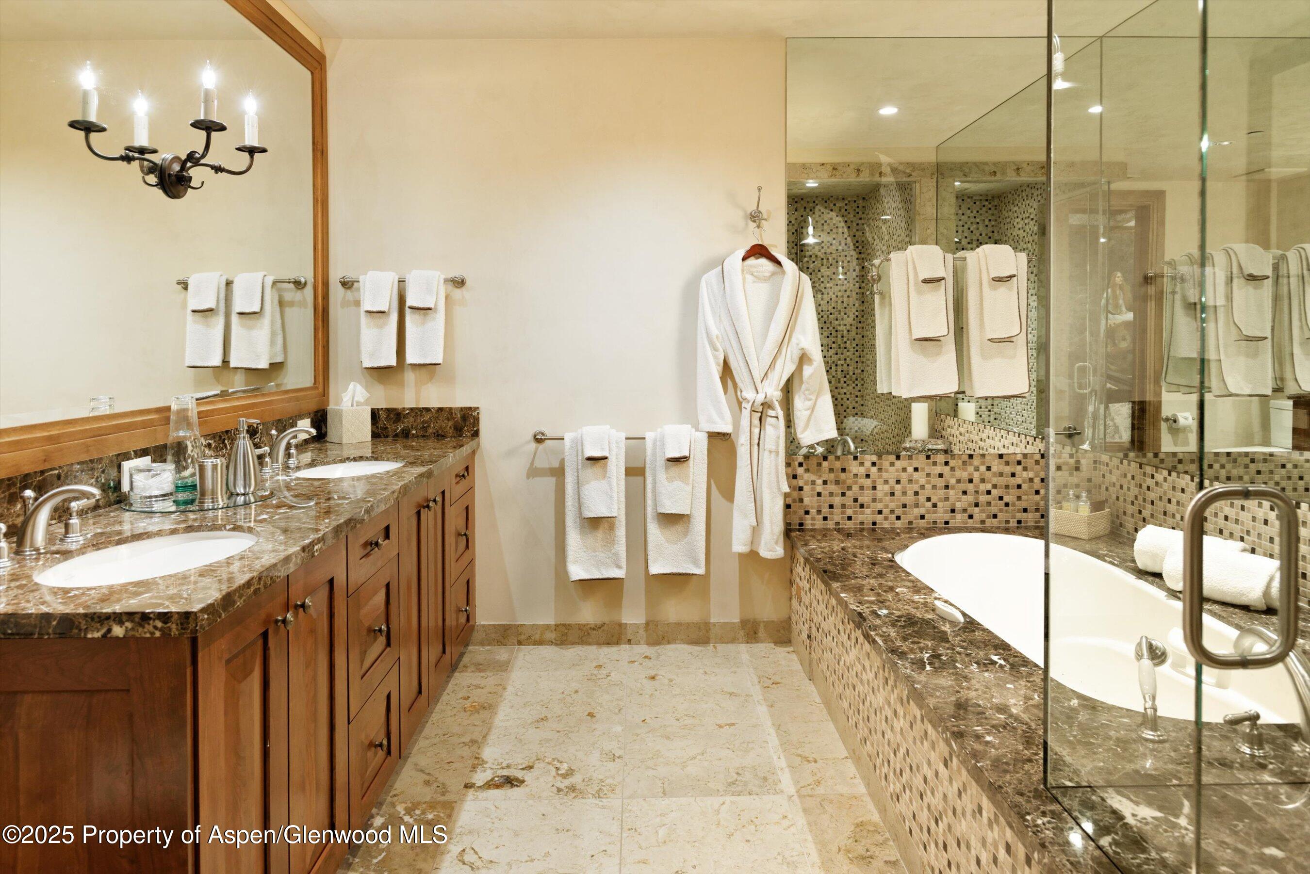 220 Buttermilk Lane Aspen, CO 81611 - Photo 23 of 60 a bathroom with a tub sink shower and mirror