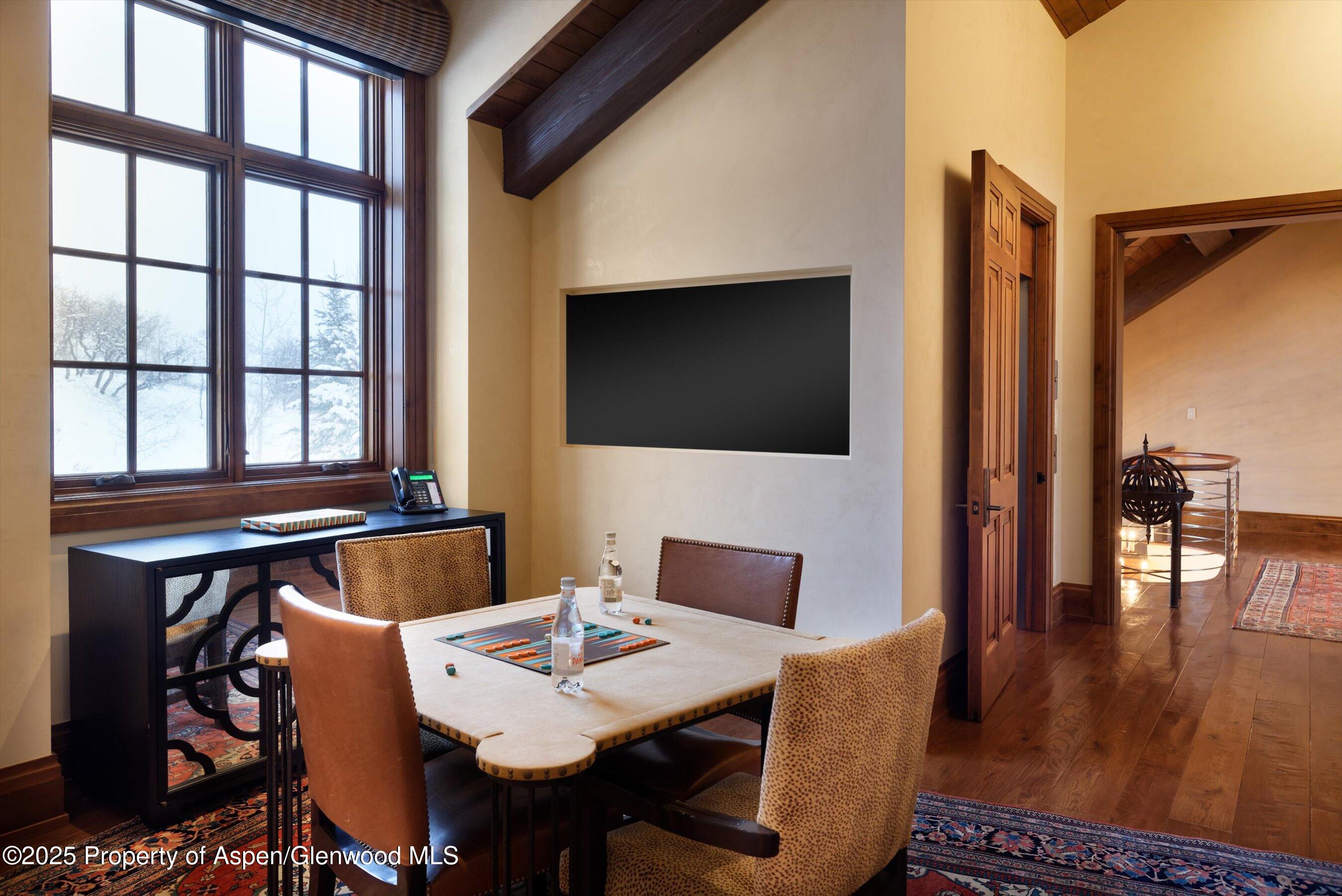 220 Buttermilk Lane Aspen, CO 81611 - Photo 32 of 60 a view of a dining room with furniture and wooden floor