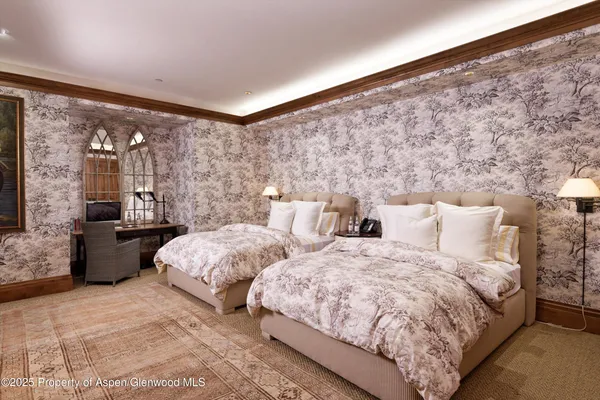 a bedroom with a bed closet and a large window