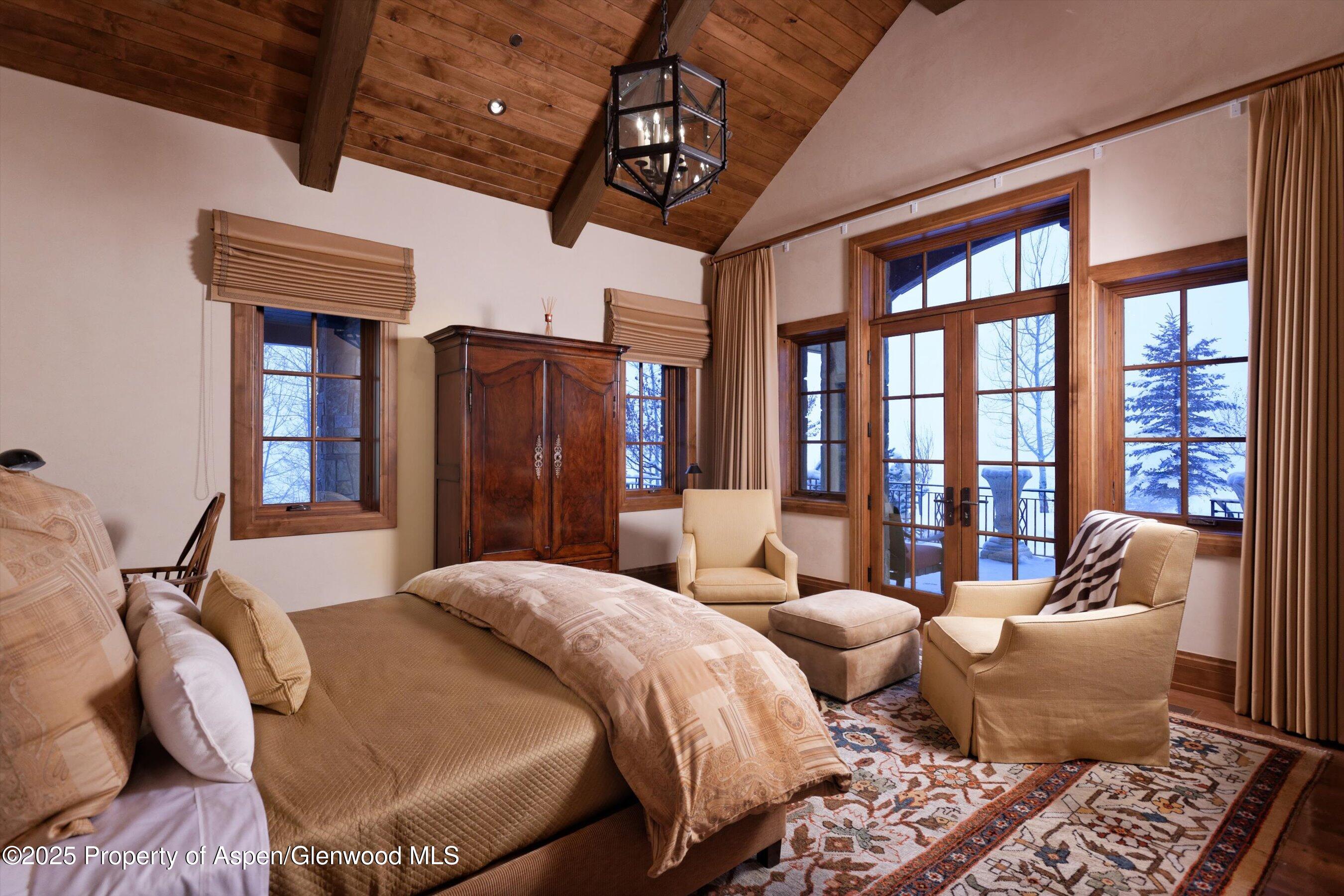 220 Buttermilk Lane Aspen, CO 81611 - Photo 5 of 60 a bed room with two beds and a chandelier