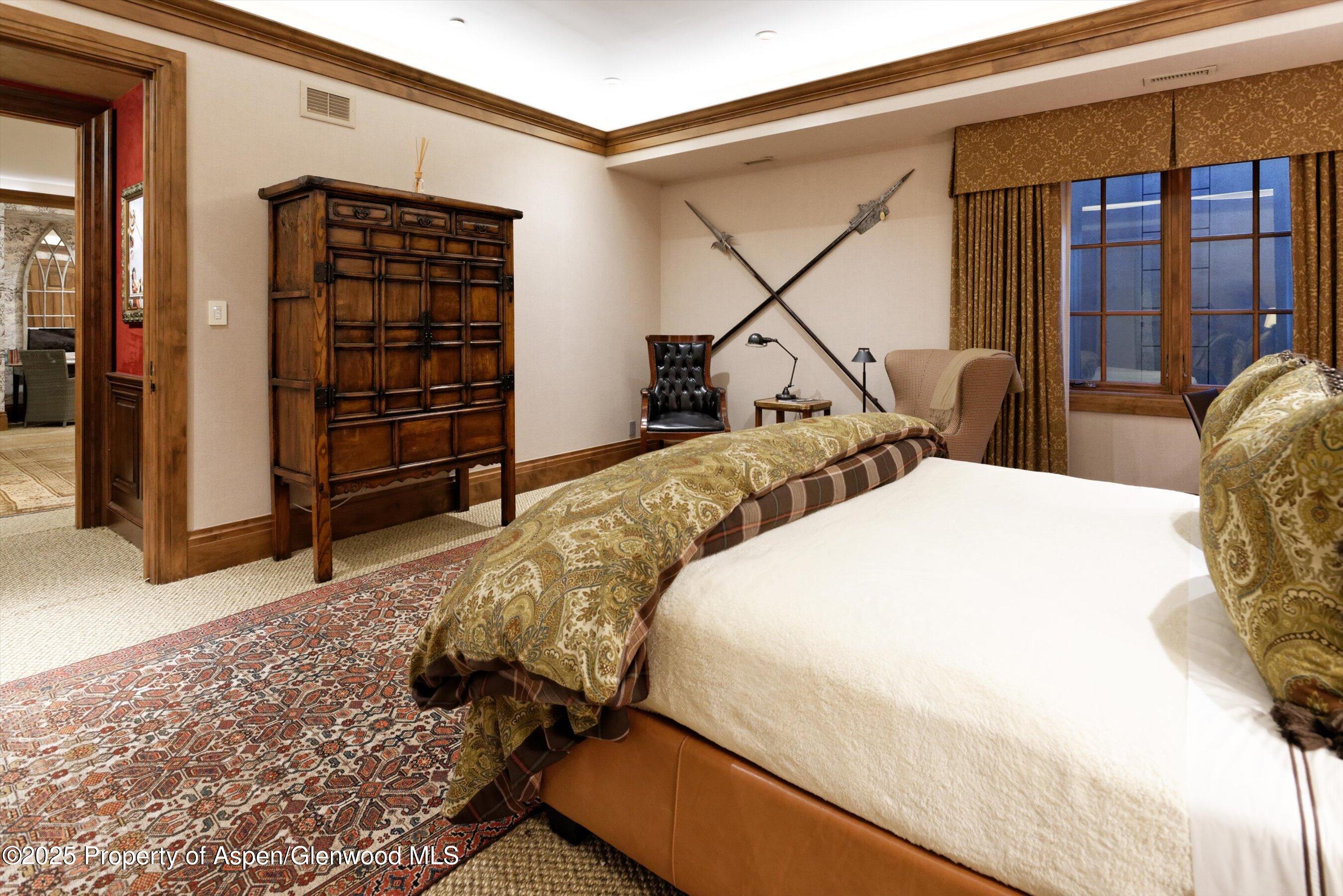 220 Buttermilk Lane Aspen, CO 81611 - Photo 6 of 60 a bedroom with a bed a dresser and a large window