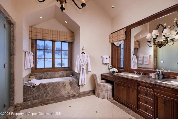 a living room with fireplace furniture and a chandelier