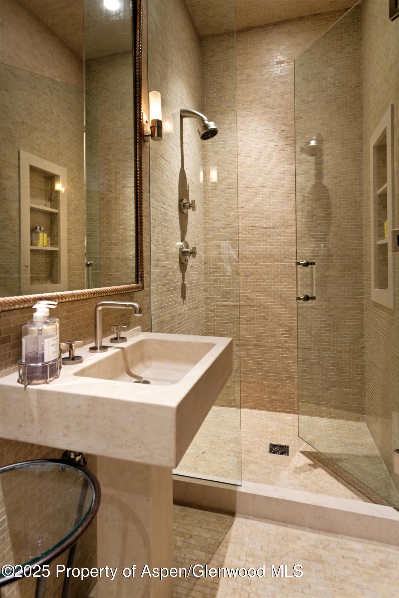 220 Buttermilk Lane Aspen, CO 81611 - Photo 8 of 60 a bathroom with a sink and a mirror
