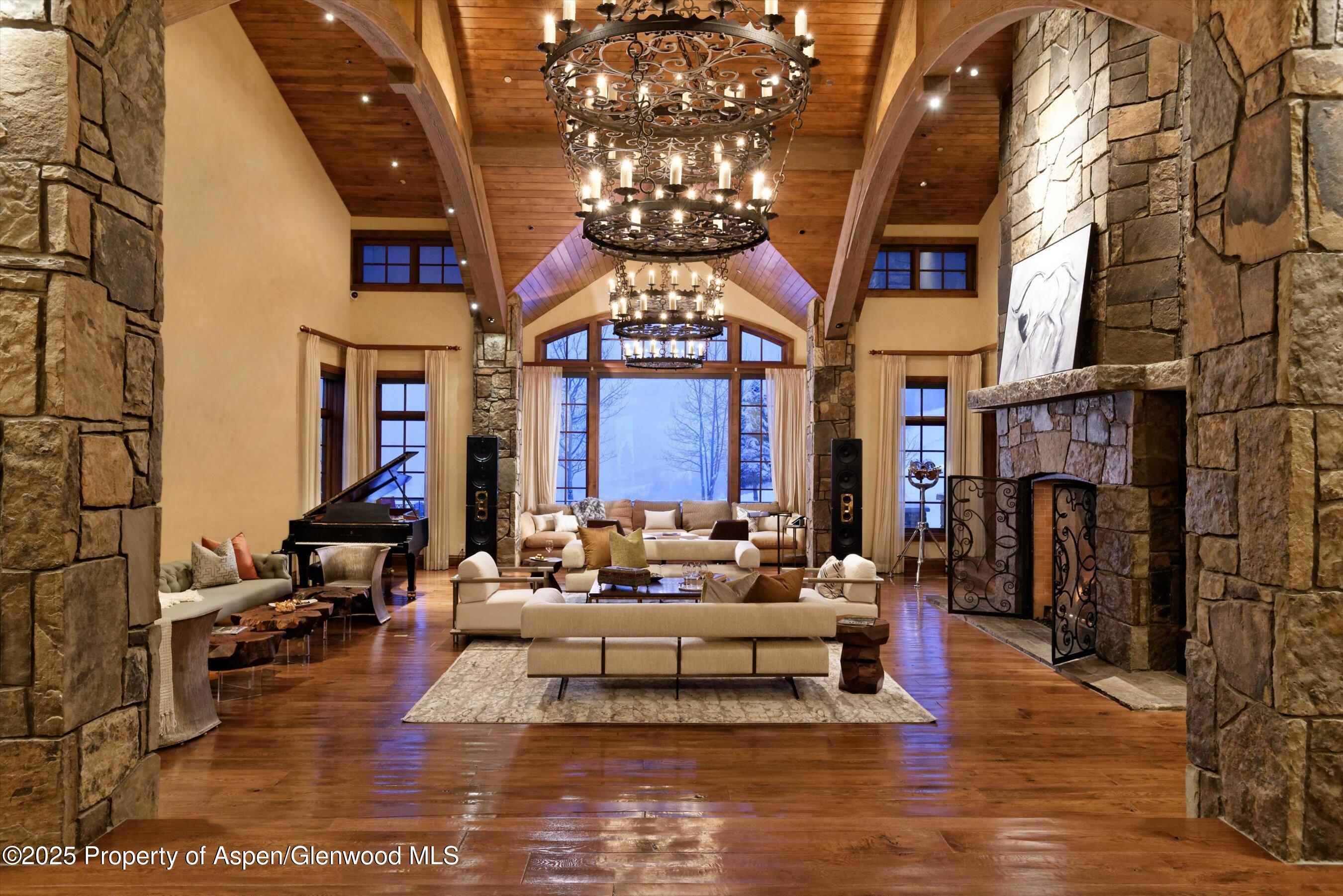 220 Buttermilk Lane Aspen, CO 81611 - Photo 9 of 60 a living room with fireplace furniture and a chandelier