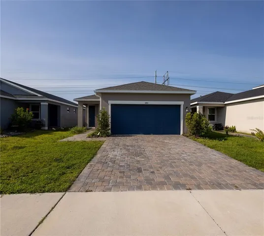 a front view of a house with a yard and garage