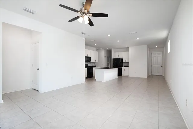 a view of a kitchen with a sink and a refrigerator