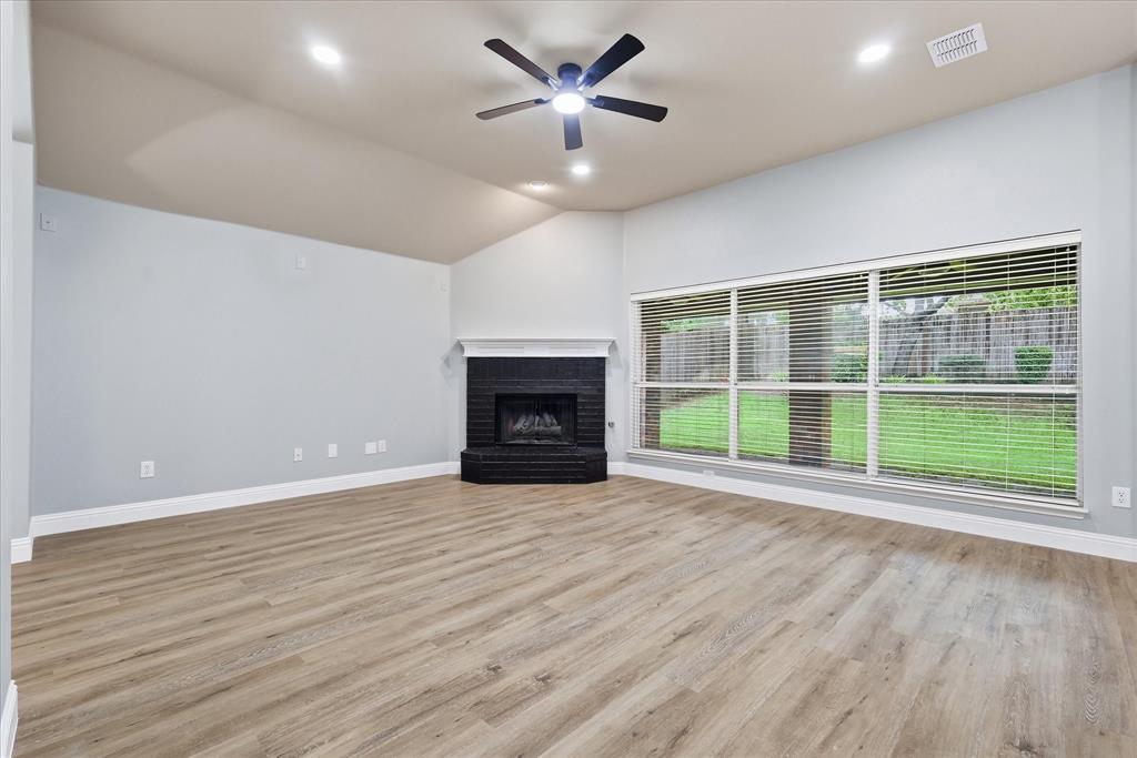 2616 Hollow Ridge Drive Denton, TX 76210 - Photo 9 of 31 Spacious living area featuring vaulted ceilings, recessed lighting, and wood-finish flooring