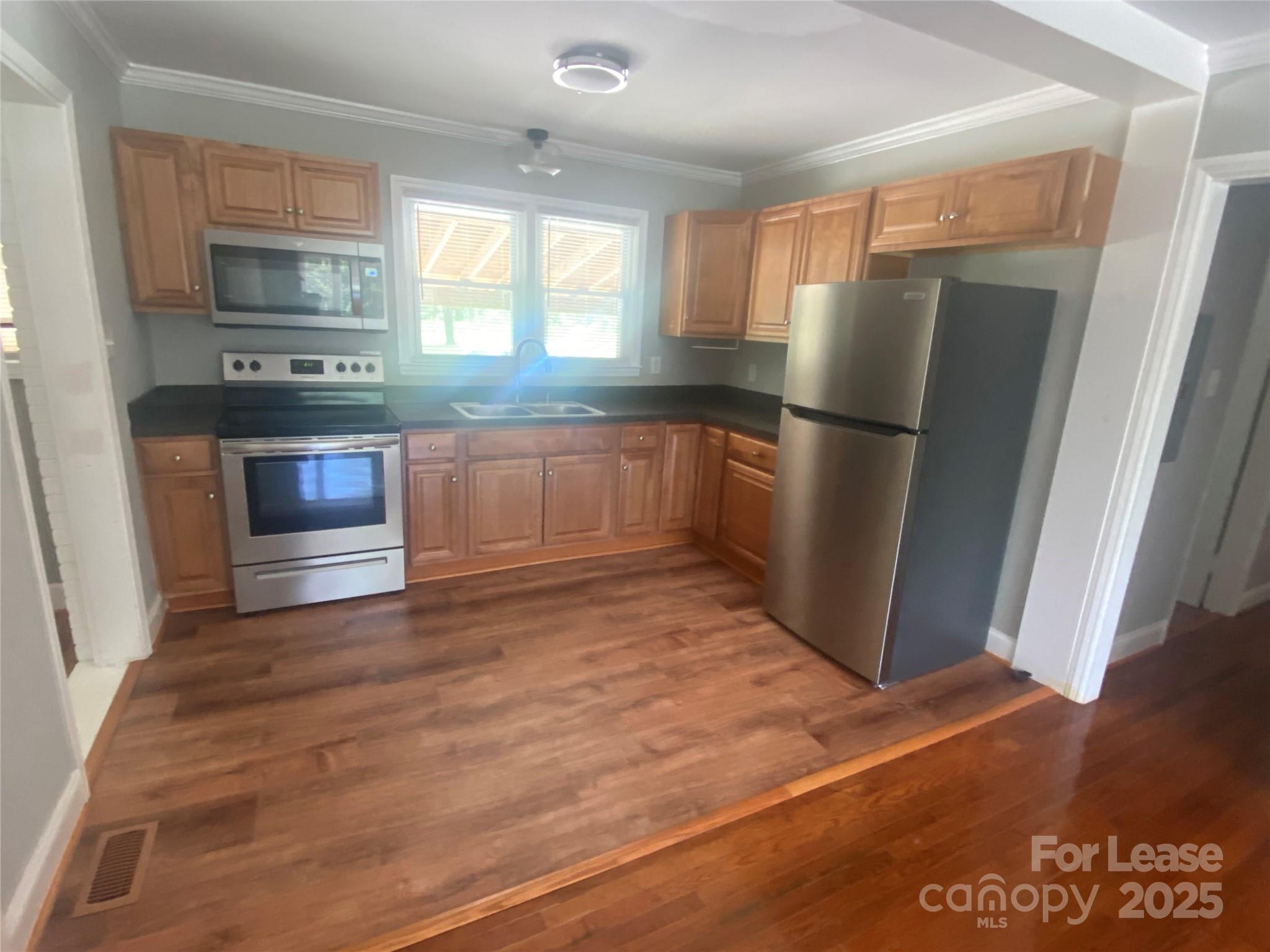 4530 Shiloh Unity Road Lancaster, SC 29720 - Photo 5 of 14 a kitchen with granite countertop a refrigerator and a stove top oven