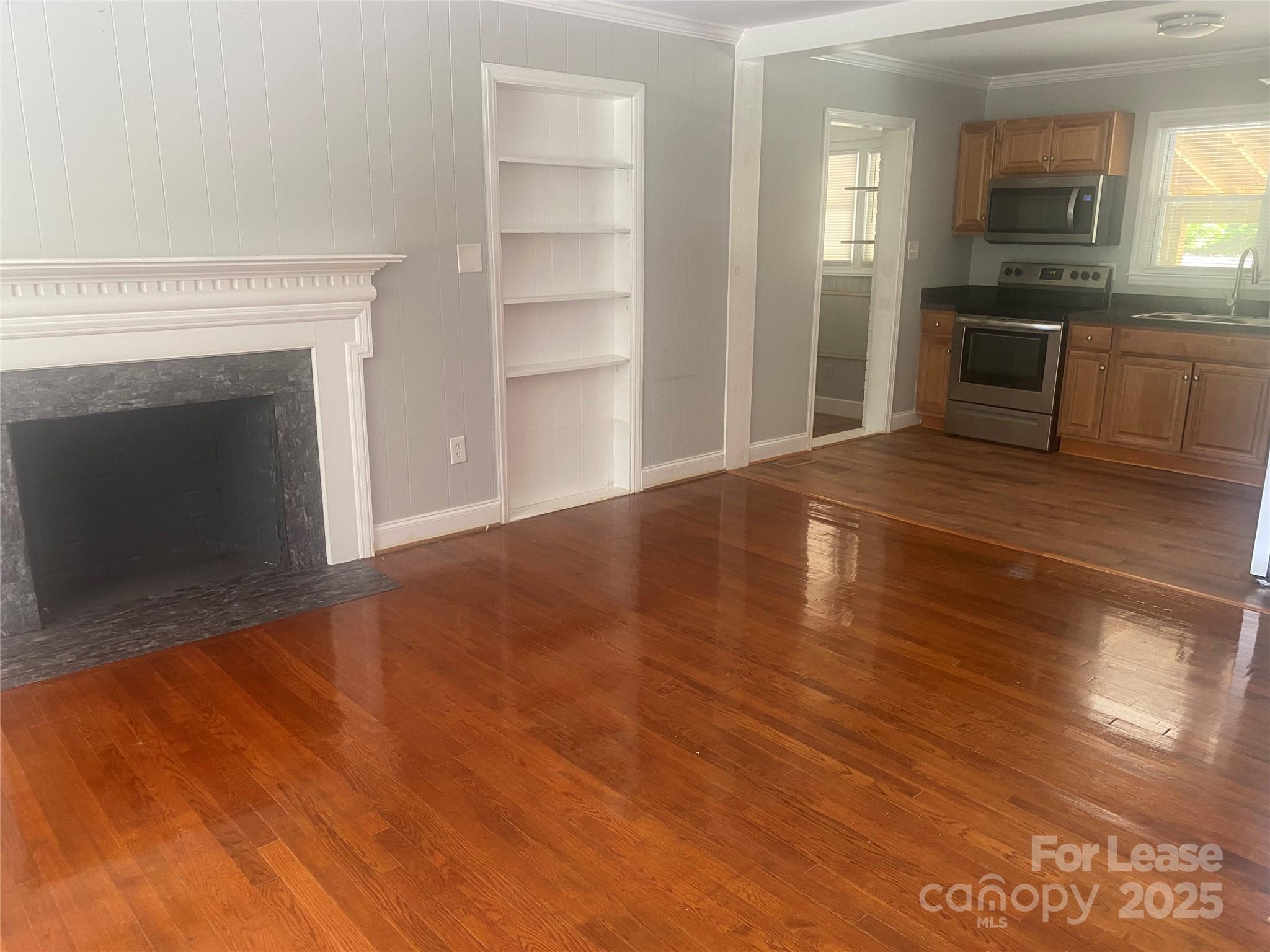 4530 Shiloh Unity Road Lancaster, SC 29720 - Photo 7 of 14 a view of a kitchen and an empty room with a fireplace