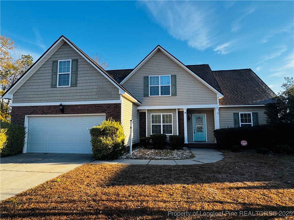1516 Rough Rider Lane Parkton, NC 28371 - Photo 1 of 23 a front view of a house with a yard and potted plants