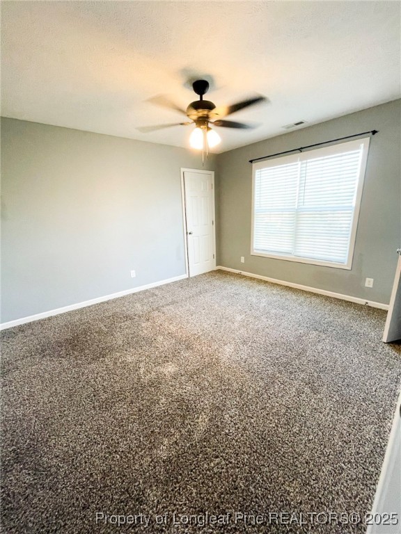 1516 Rough Rider Lane Parkton, NC 28371 - Photo 19 of 23 an empty room with a ceiling fan and window