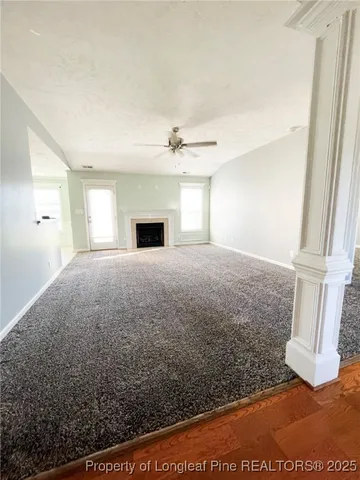a view of empty room with wooden floor