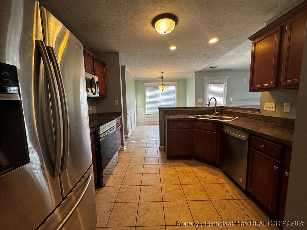 1516 Rough Rider Lane Parkton, NC 28371 - Photo 6 of 23 a kitchen with stainless steel appliances granite countertop a sink stove and refrigerator