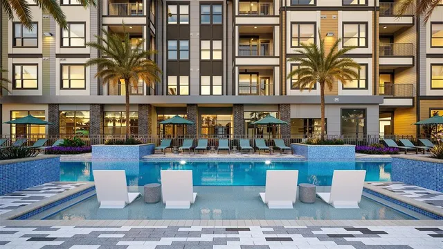 a view of a patio with couches table and chairs and potted plants