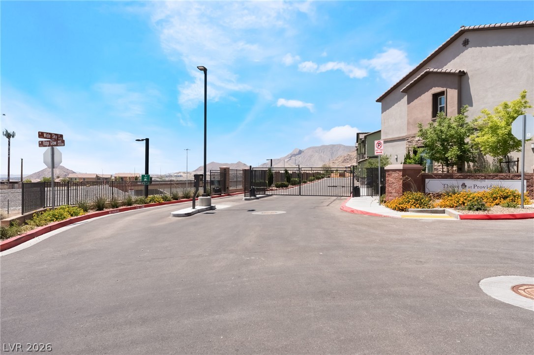 6432 Spring Jog Street Las Vegas, NV 89166 - Photo 38 of 61 Secure community entrance with mountain vistas awaits.