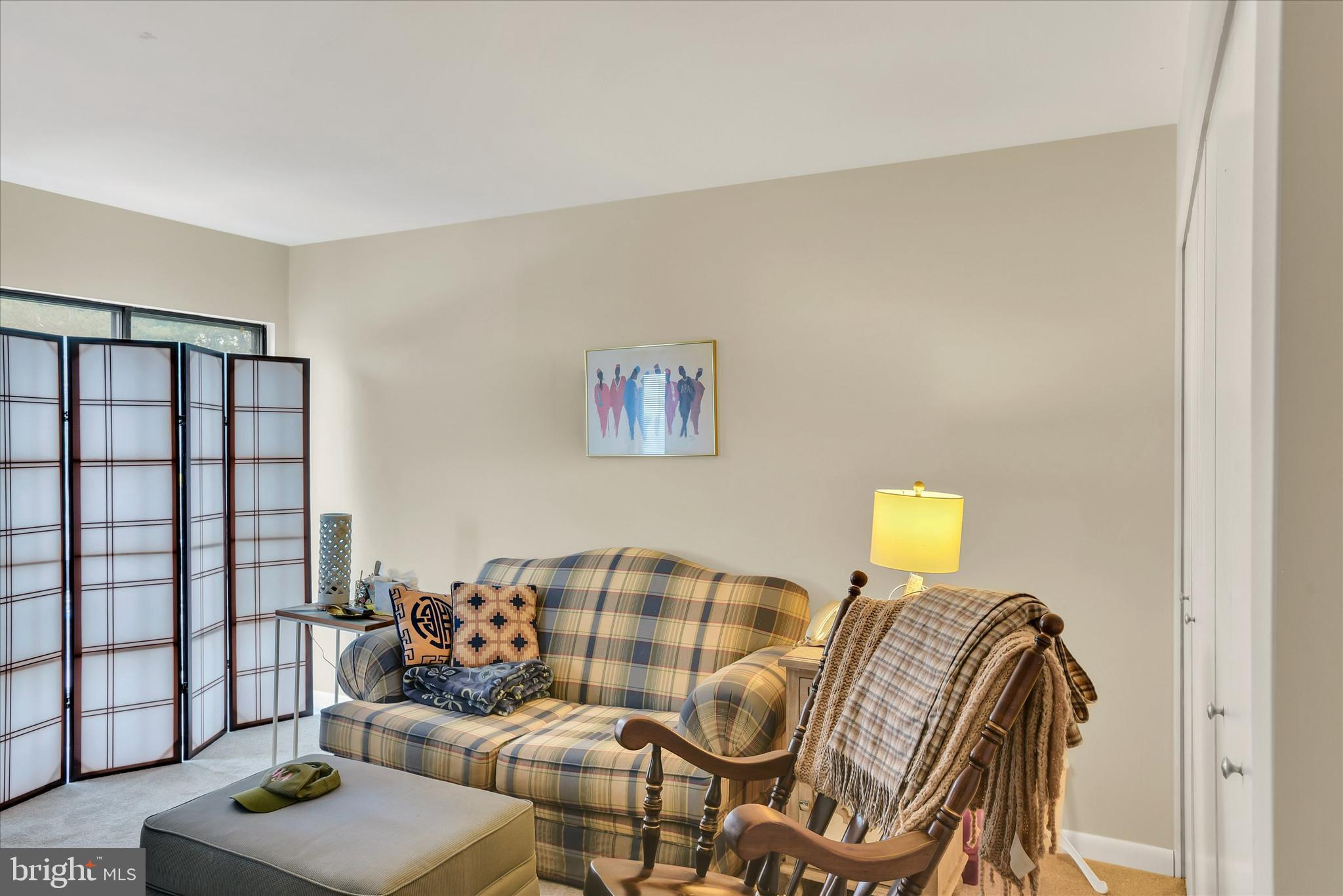 41 Stirrup Court, Unit 7 Baltimore, MD 21208 - Photo 14 of 34 a living room with furniture and a floor to ceiling window