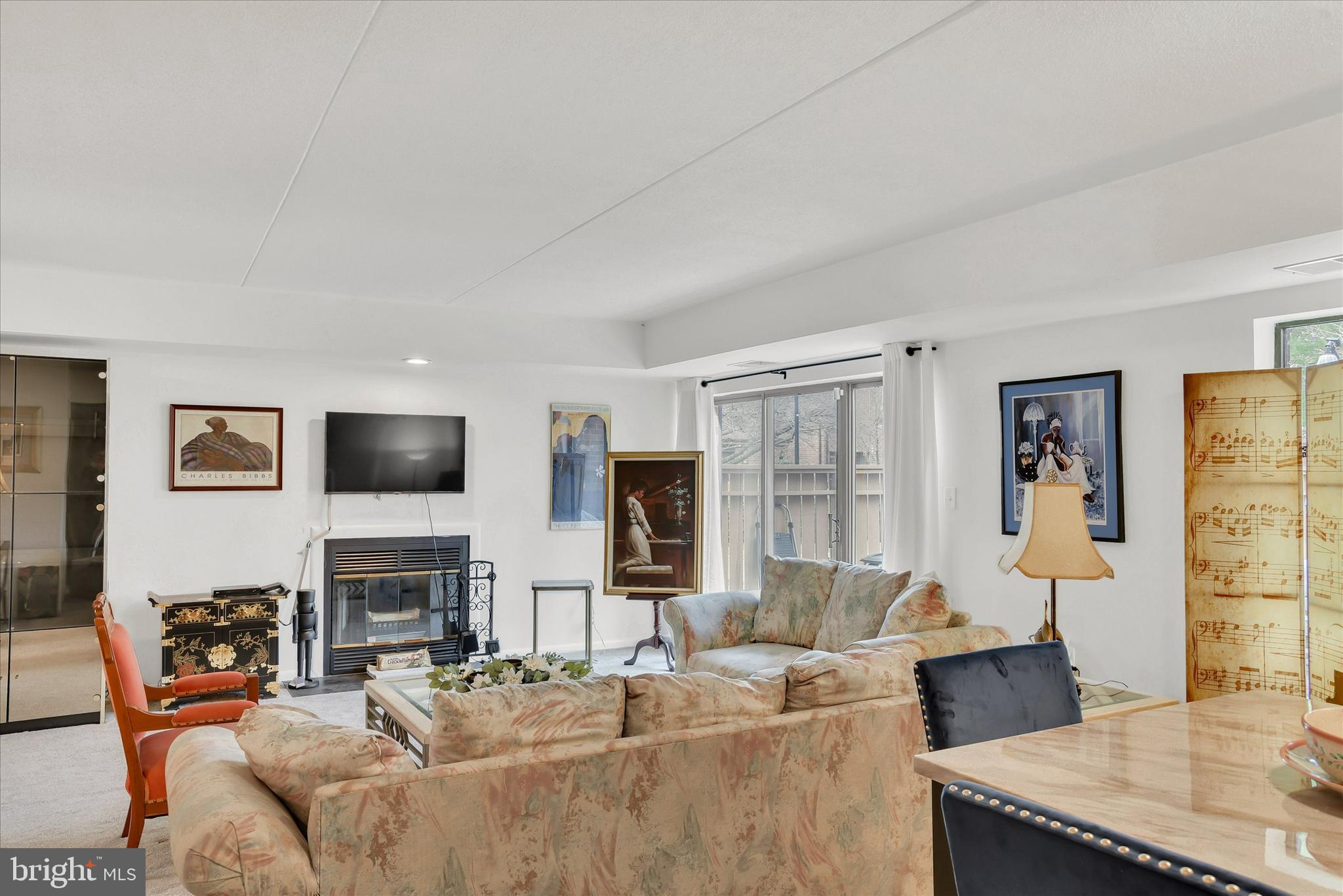41 Stirrup Court, Unit 7 Baltimore, MD 21208 - Photo 5 of 34 a living room with furniture a fireplace and a flat screen tv