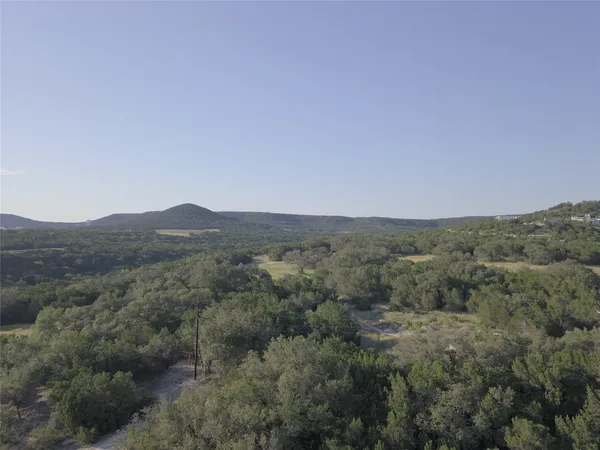 a view of a mountain range with trees in the background