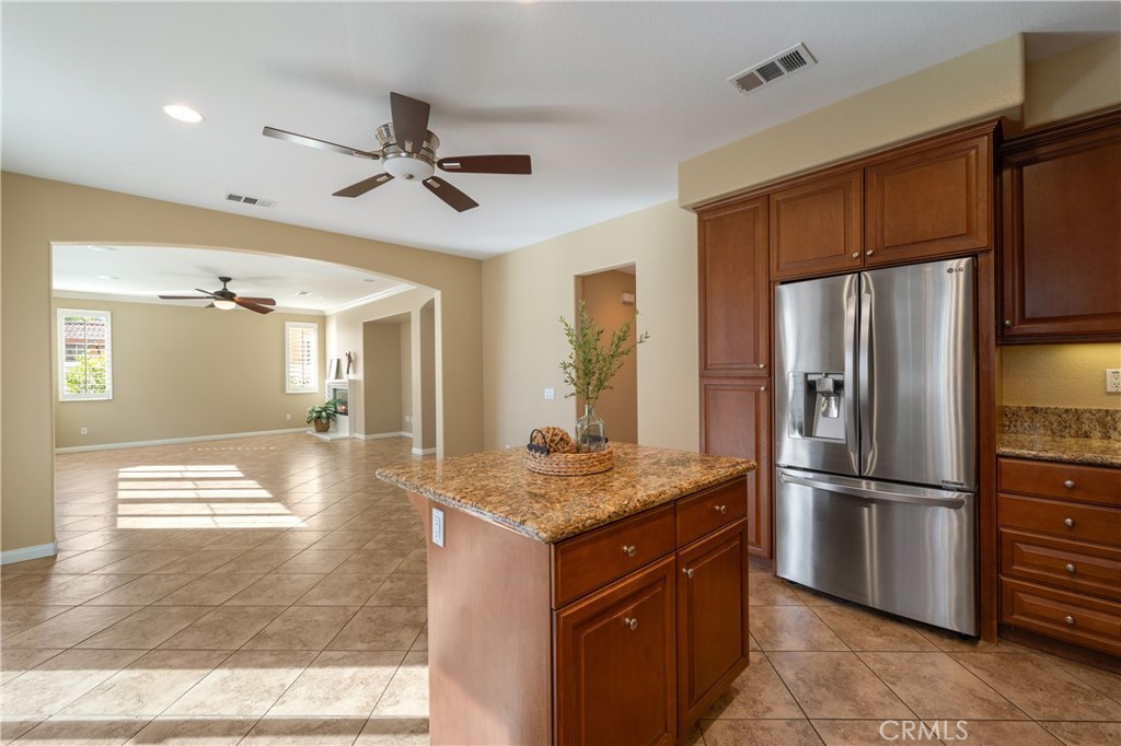 28817 Edenton Way Temecula, CA 92591 - Photo 24 of 56 a kitchen with stainless steel appliances granite countertop a refrigerator and a sink