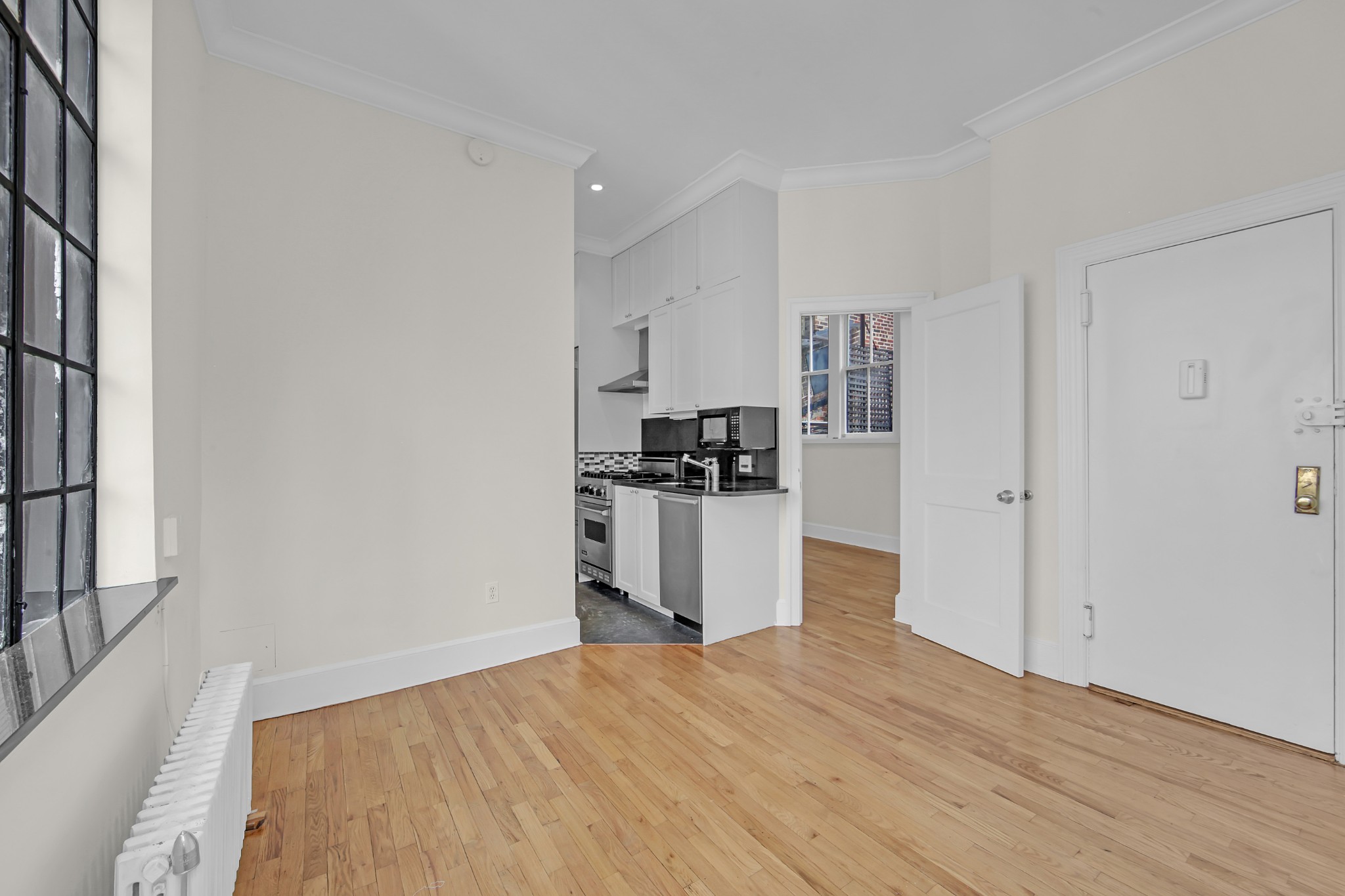 127 East 69th Street, Unit PH Manhattan, NY 10021 - Photo 6 of 11 a kitchen with a refrigerator and a stove top oven