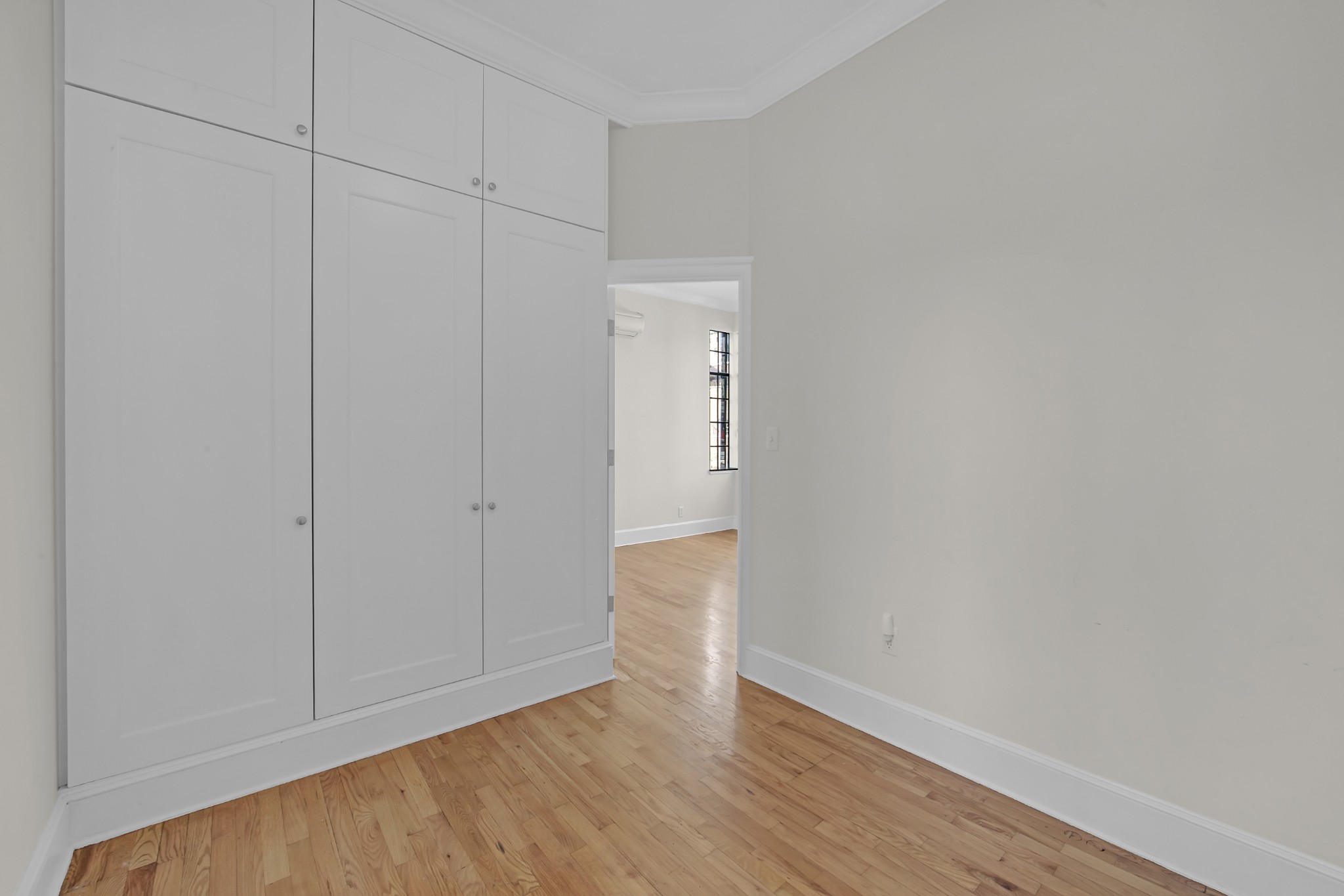 127 East 69th Street, Unit PH Manhattan, NY 10021 - Photo 8 of 11 a view of an empty room with wooden floor