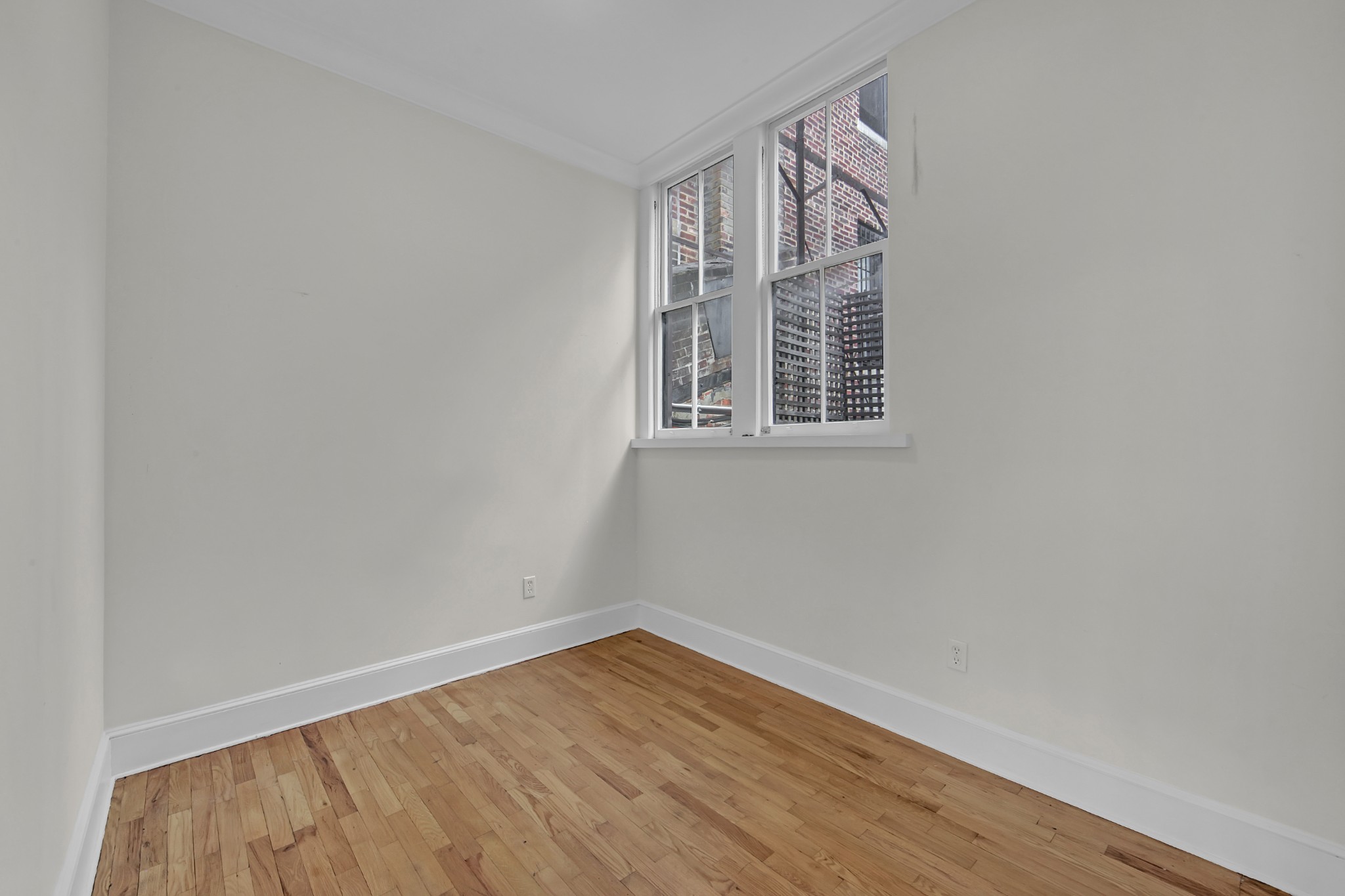 127 East 69th Street, Unit PH Manhattan, NY 10021 - Photo 9 of 11 an empty room with wooden floor and windows