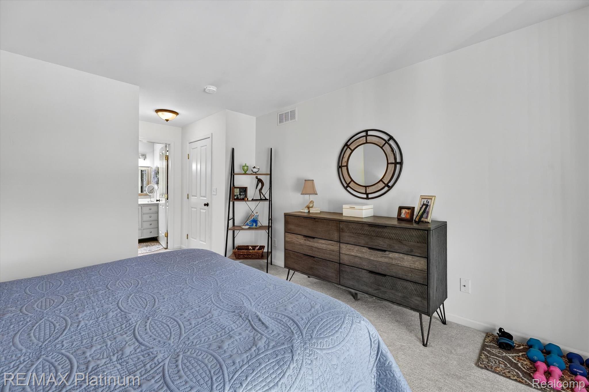 4191 Hampton Ridge Boulevard, Unit 41 Howell, MI 48843 - Photo 10 of 23 Bedroom featuring light carpet and ensuite bath