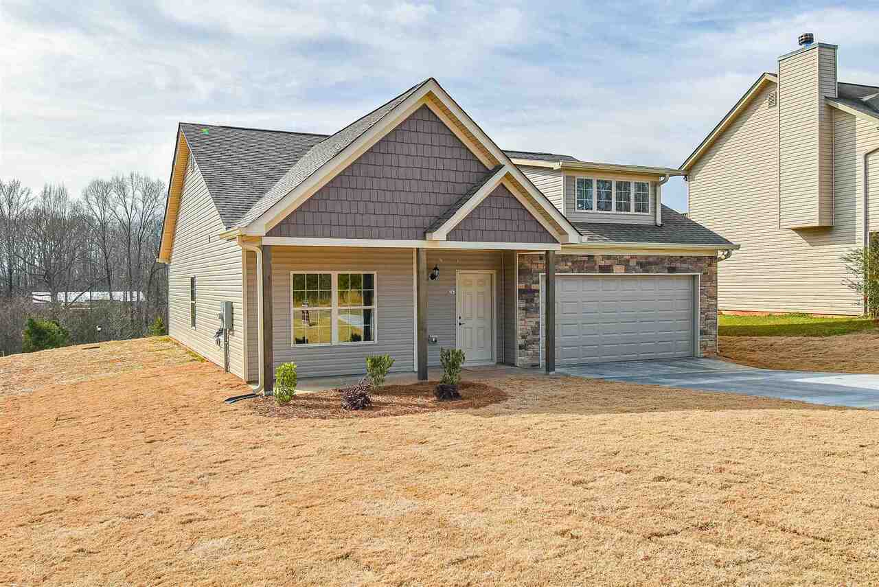 3059 Cedar Ridge Road, Unit 12 Commerce, GA 30530 - Photo 1 of 1 a front view of a house with a garden