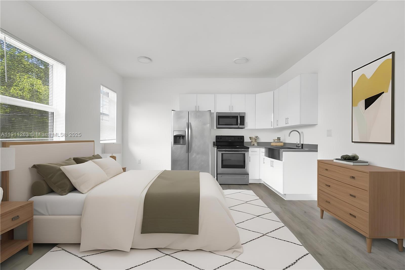 402 Northwest 12th Avenue, Unit 210 Miami, FL 33128 - Photo 1 of 16 a large white open kitchen with white cabinets and stainless steel appliances