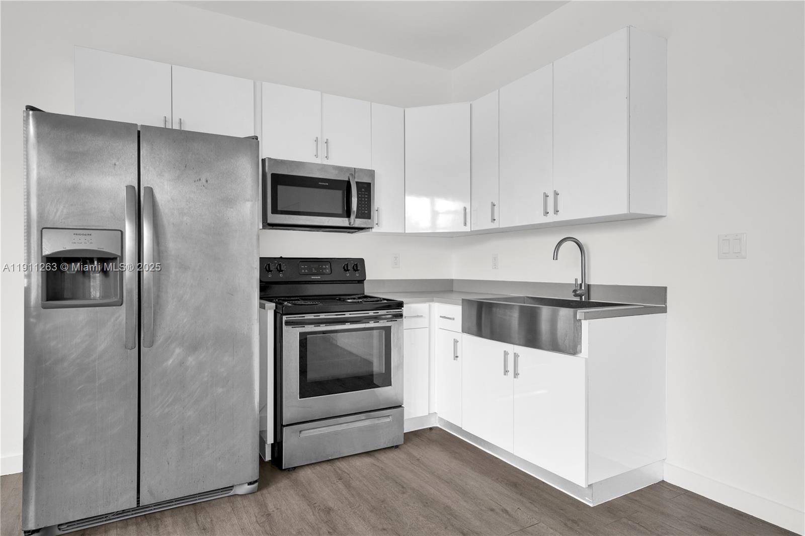 402 Northwest 12th Avenue, Unit 210 Miami, FL 33128 - Photo 9 of 16 a kitchen with stainless steel appliances a refrigerator sink and microwave