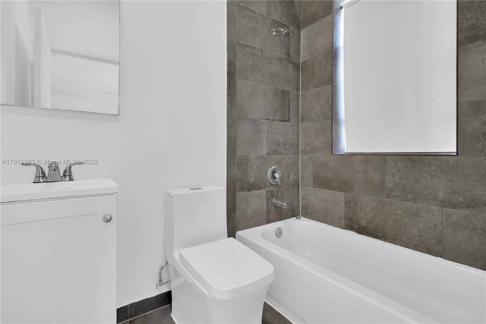 402 Northwest 12th Avenue, Unit 210 Miami, FL 33128 - Photo 10 of 16 a bathroom with a sink a toilet and shower