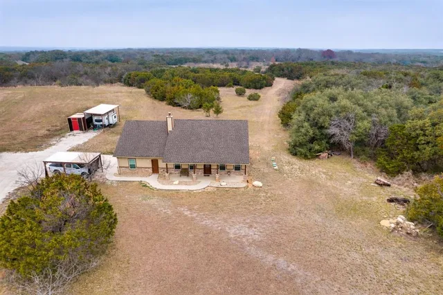 an aerial view of a house with a lake view