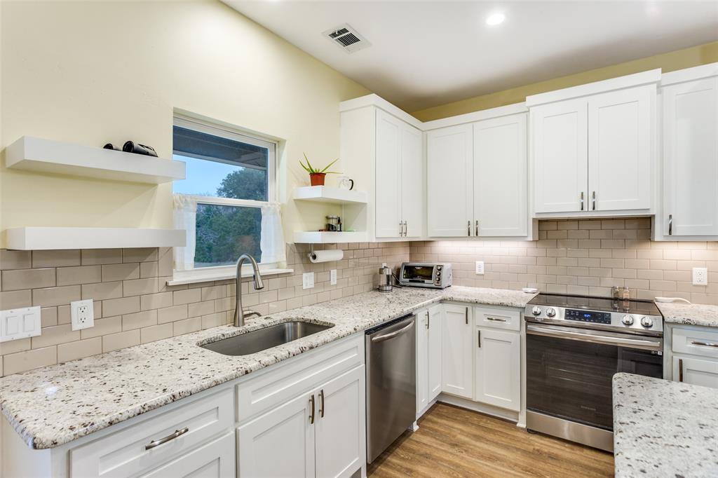 198 Fort Graham Whitney, TX 76692 - Photo 17 of 30 a kitchen with a sink stove and cabinets