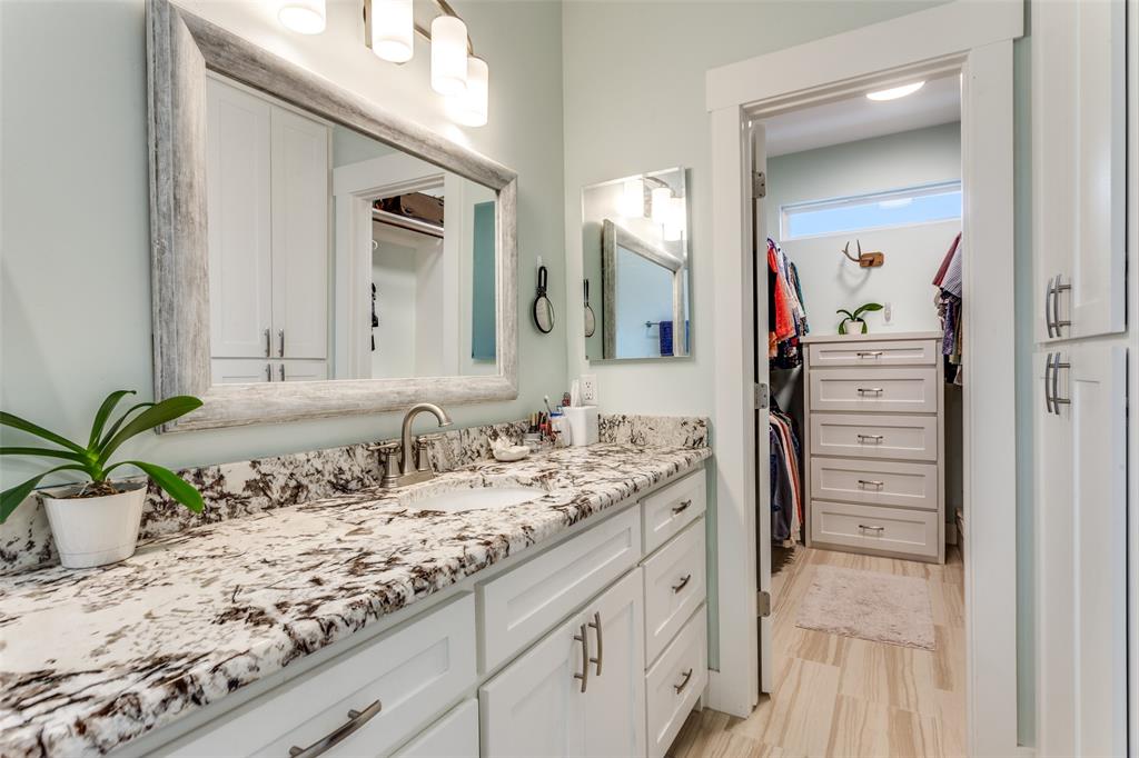 198 Fort Graham Whitney, TX 76692 - Photo 22 of 30 a bathroom with a granite countertop sink and a mirror