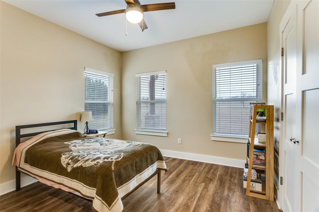 198 Fort Graham Whitney, TX 76692 - Photo 24 of 30 a bedroom with a bed and wooden floor