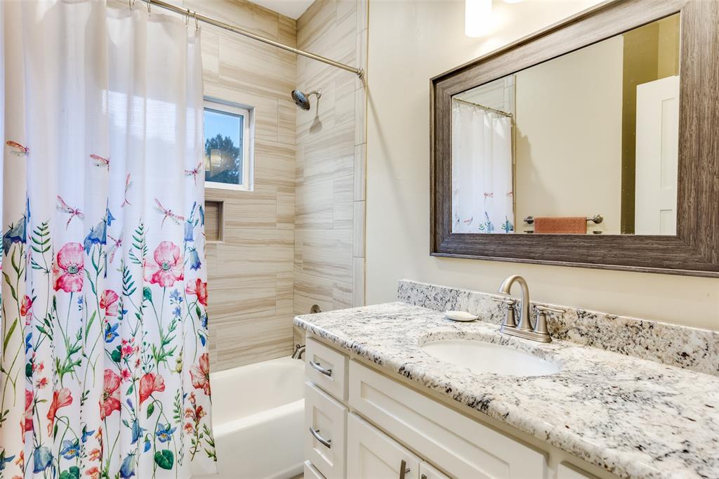 198 Fort Graham Whitney, TX 76692 - Photo 26 of 30 a bathroom with a granite countertop sink a mirror and shower