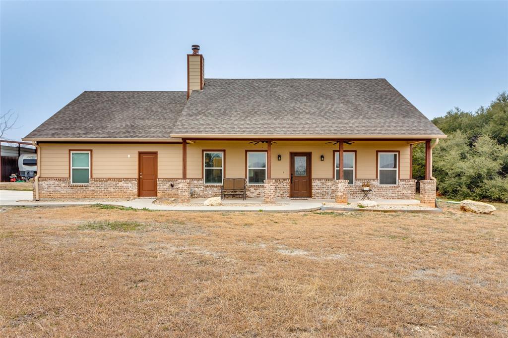 198 Fort Graham Whitney, TX 76692 - Photo 5 of 30 a front view of a house with a garden and yard