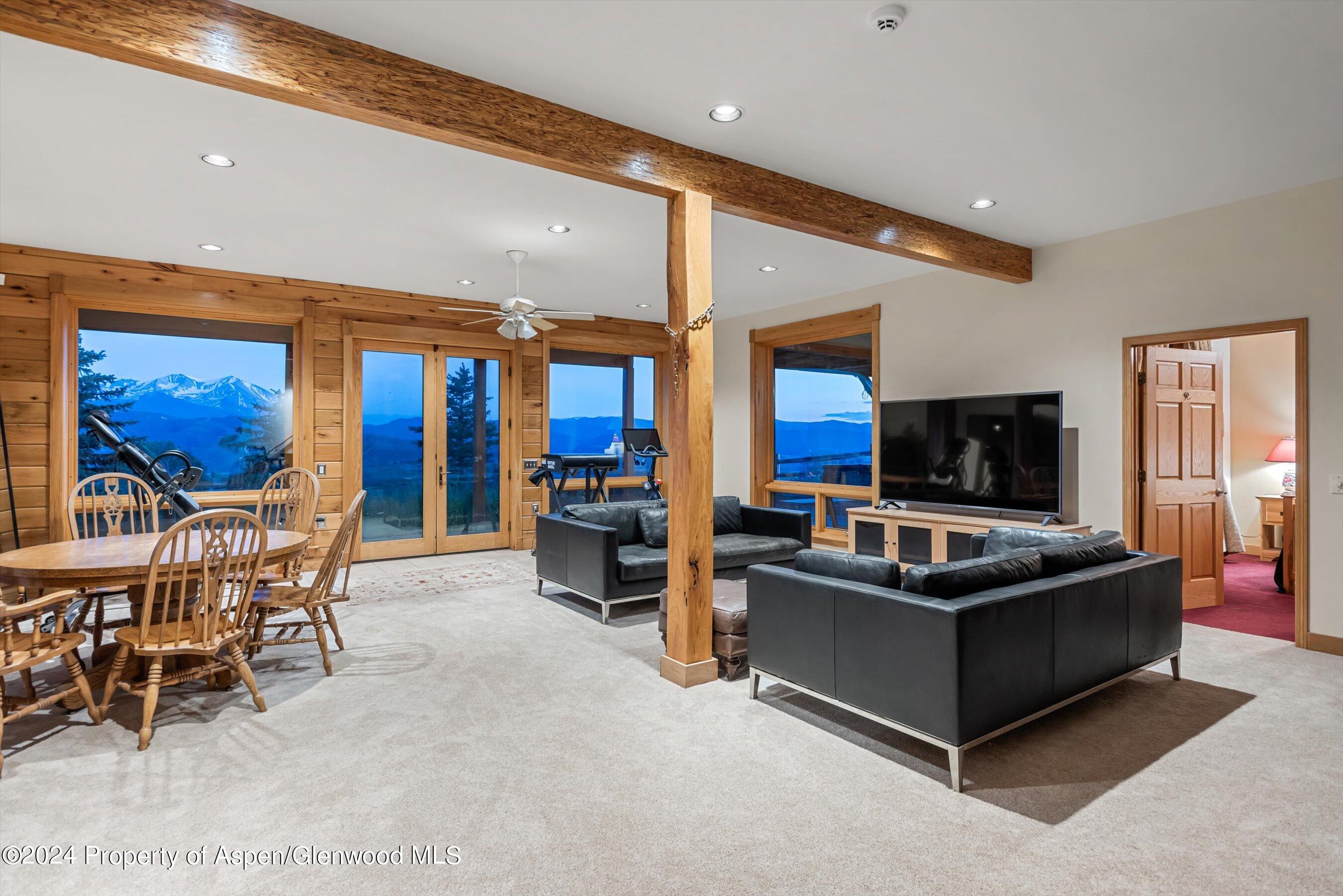 303 Park Meadows Lane Carbondale, CO 81623 - Photo 20 of 47 a living room with furniture a flat screen tv and a large window
