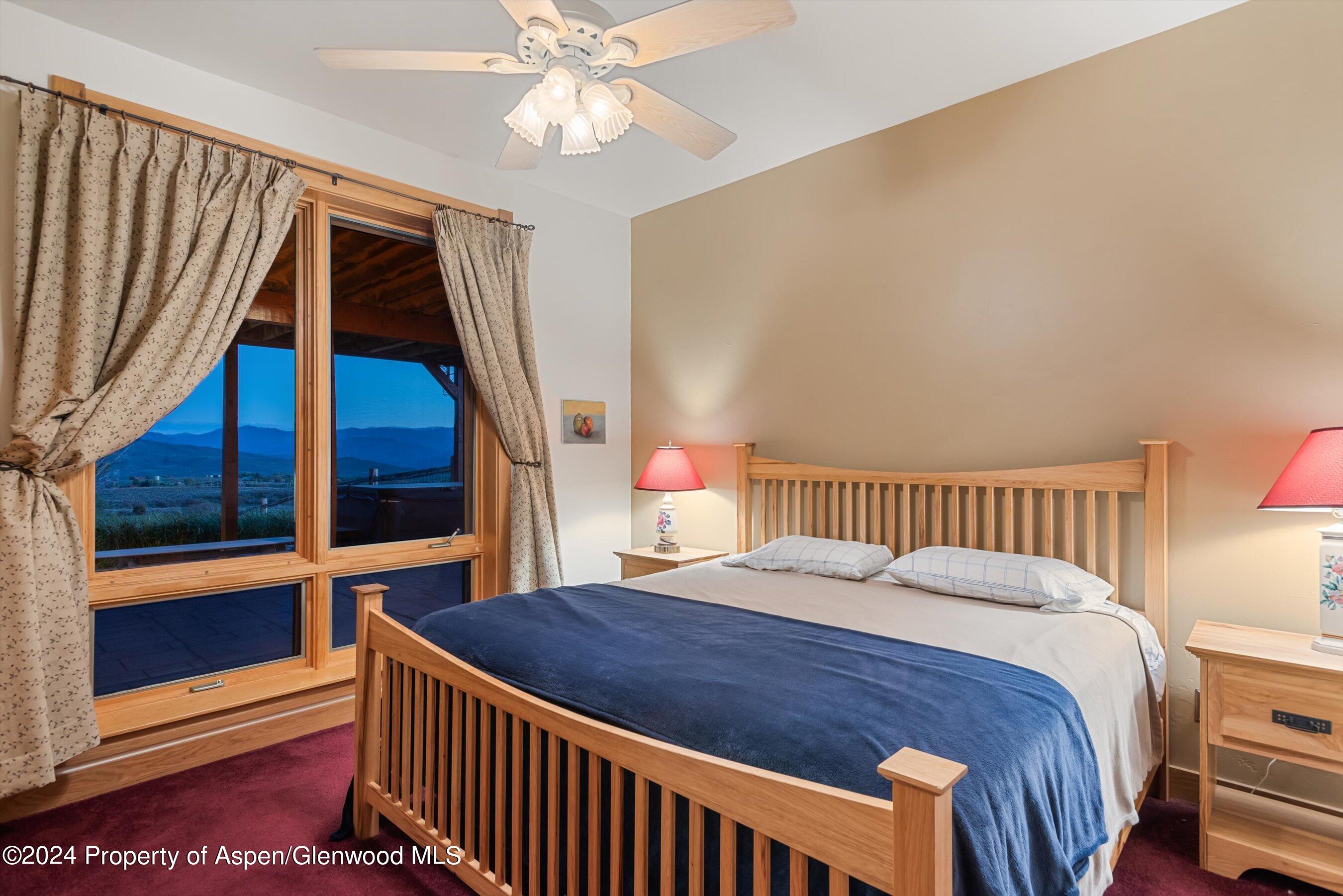 303 Park Meadows Lane Carbondale, CO 81623 - Photo 22 of 47 a bedroom with a bed and a large window