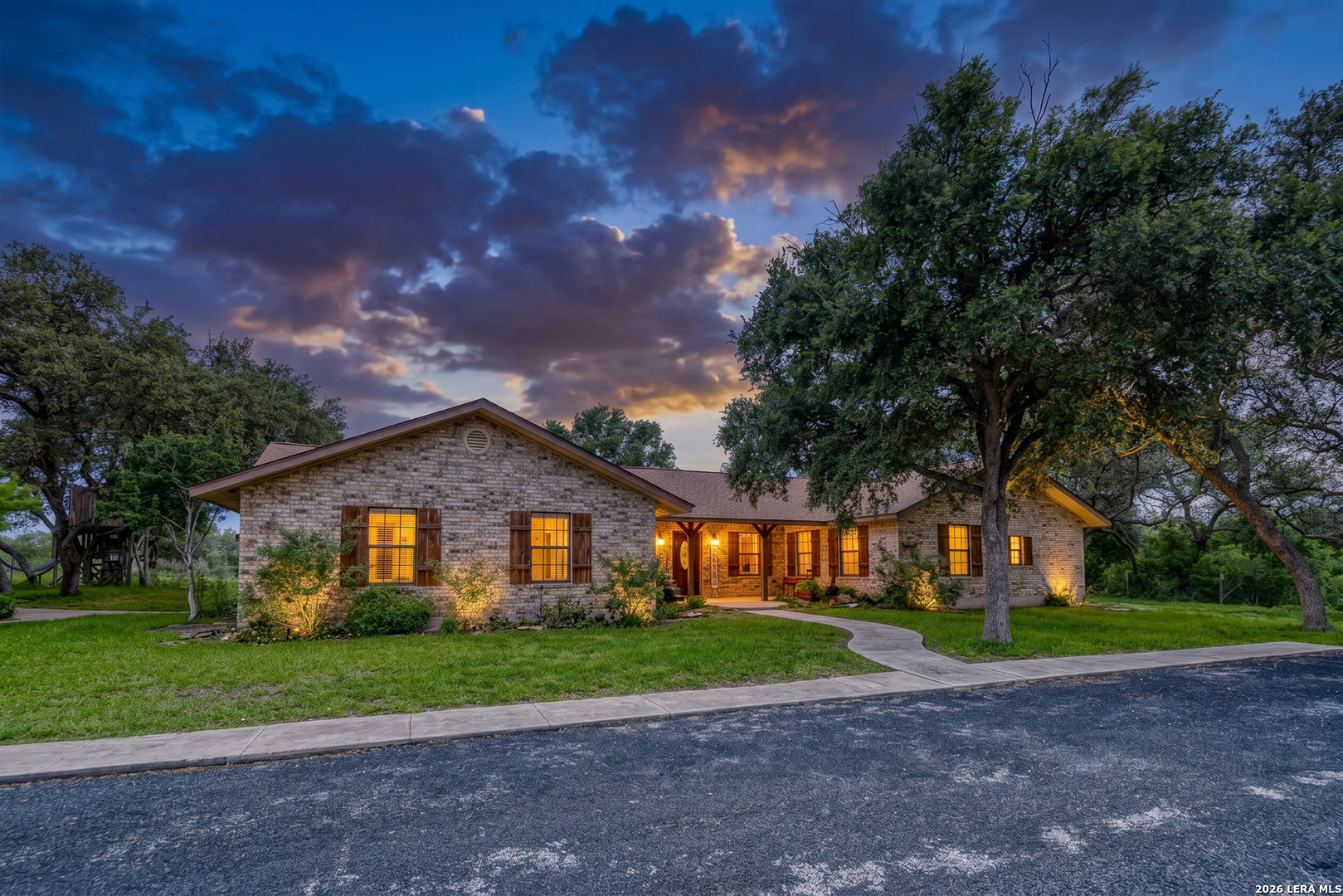 335 Sunset Ridge Road Uvalde, TX 78801 - Photo 4 of 8 a view of a house with a big yard plants and large trees