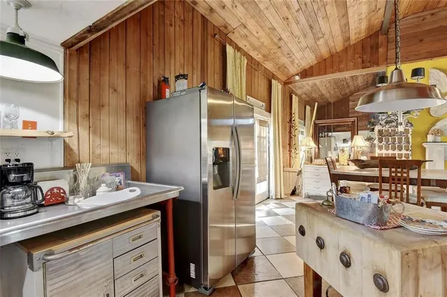 a kitchen with stainless steel appliances kitchen island granite countertop a sink and cabinets