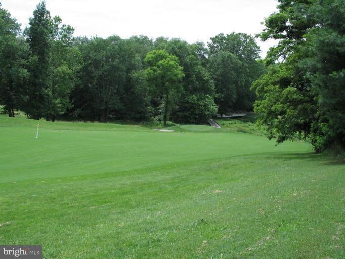 4932 Columbia Road, Unit 7 Columbia, MD 21044 - Photo 13 of 19 a view of a grassy field with trees in the background