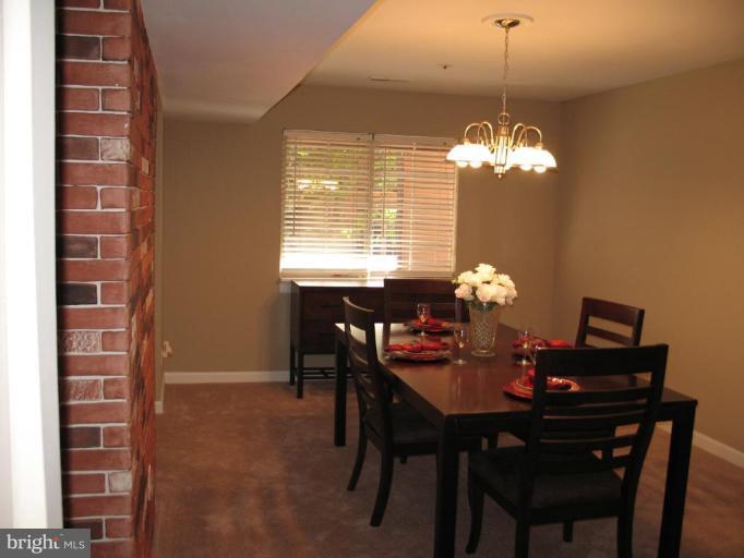 4932 Columbia Road, Unit 7 Columbia, MD 21044 - Photo 16 of 19 a view of a dining room with furniture and chandelier