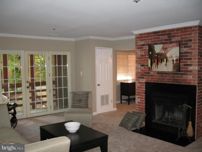 4932 Columbia Road, Unit 7 Columbia, MD 21044 - Photo 18 of 19 a living room with furniture and a fireplace